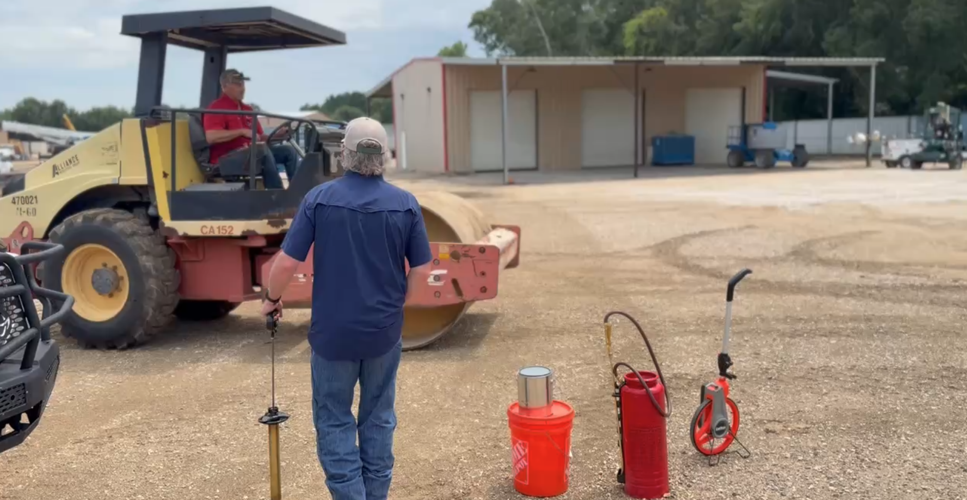 Road roller and field demonstration equipment on an aggregate surface