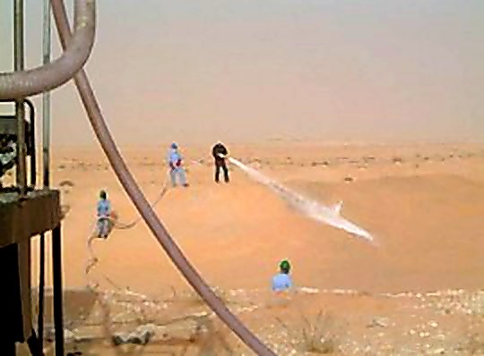 Saudi Rail Organization train on protected track — sand berm stabilization
